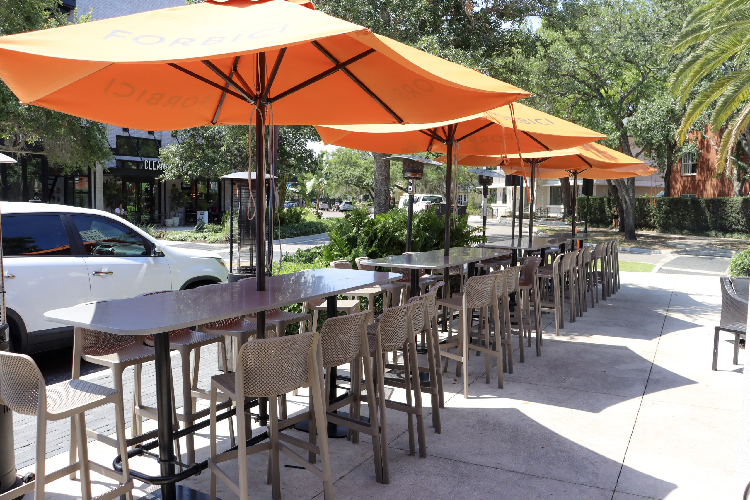 Outdoor seating with orange umbrellas outside a Tampa Bay restaurant