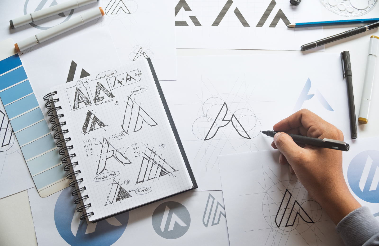 Overhead view of a hand drafting a brand logo