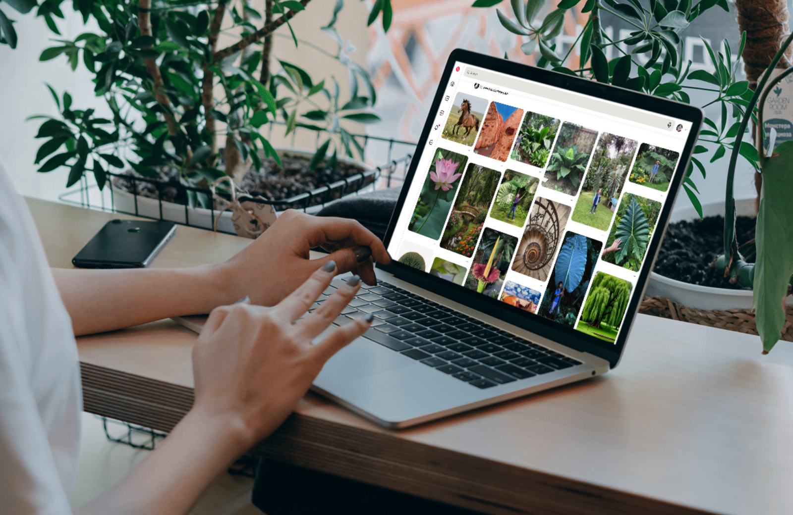 Woman at modern coffee shop browsing Pinterest