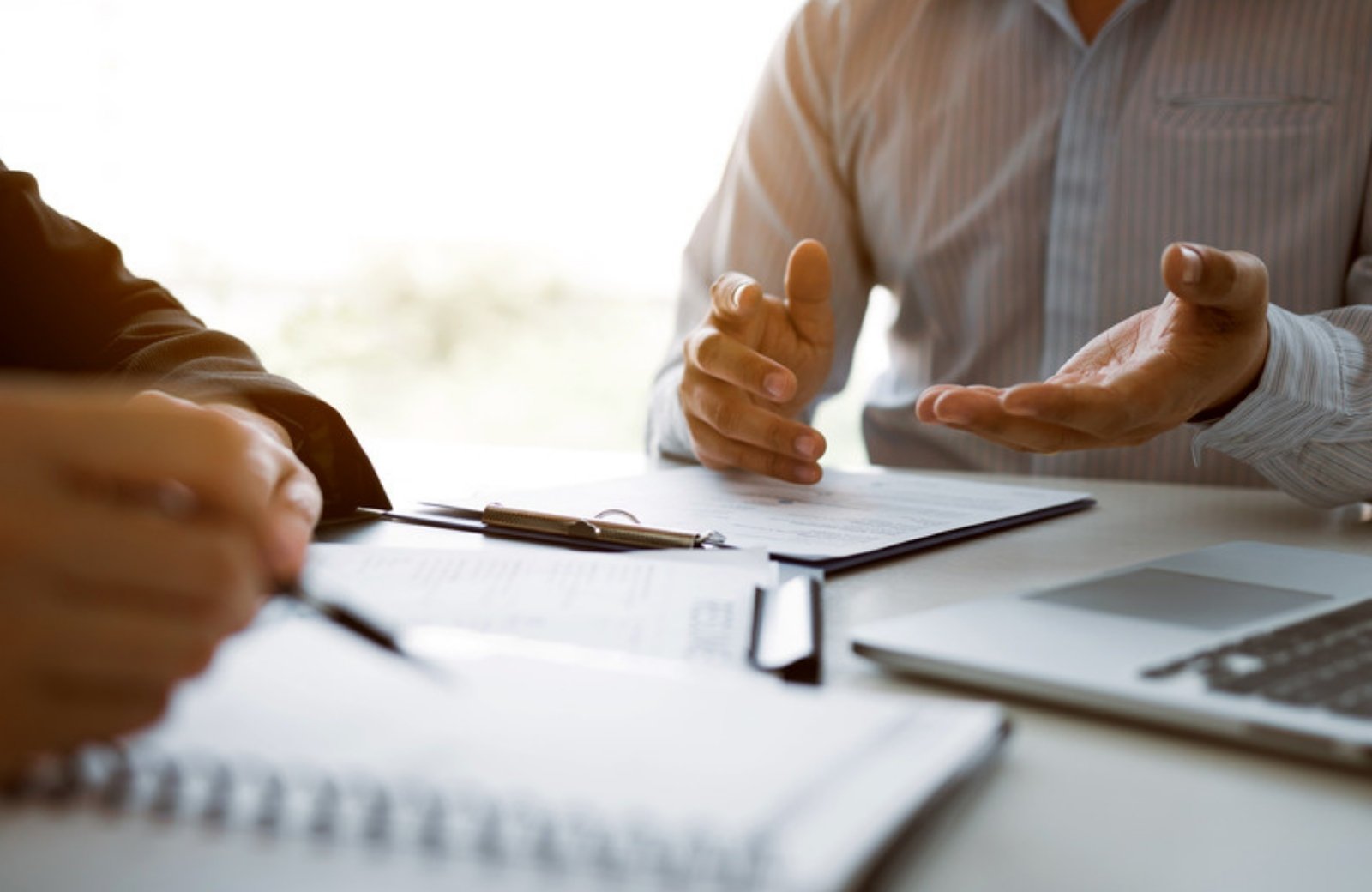 Business owner meeting with a marketing consultant to review a proposal
