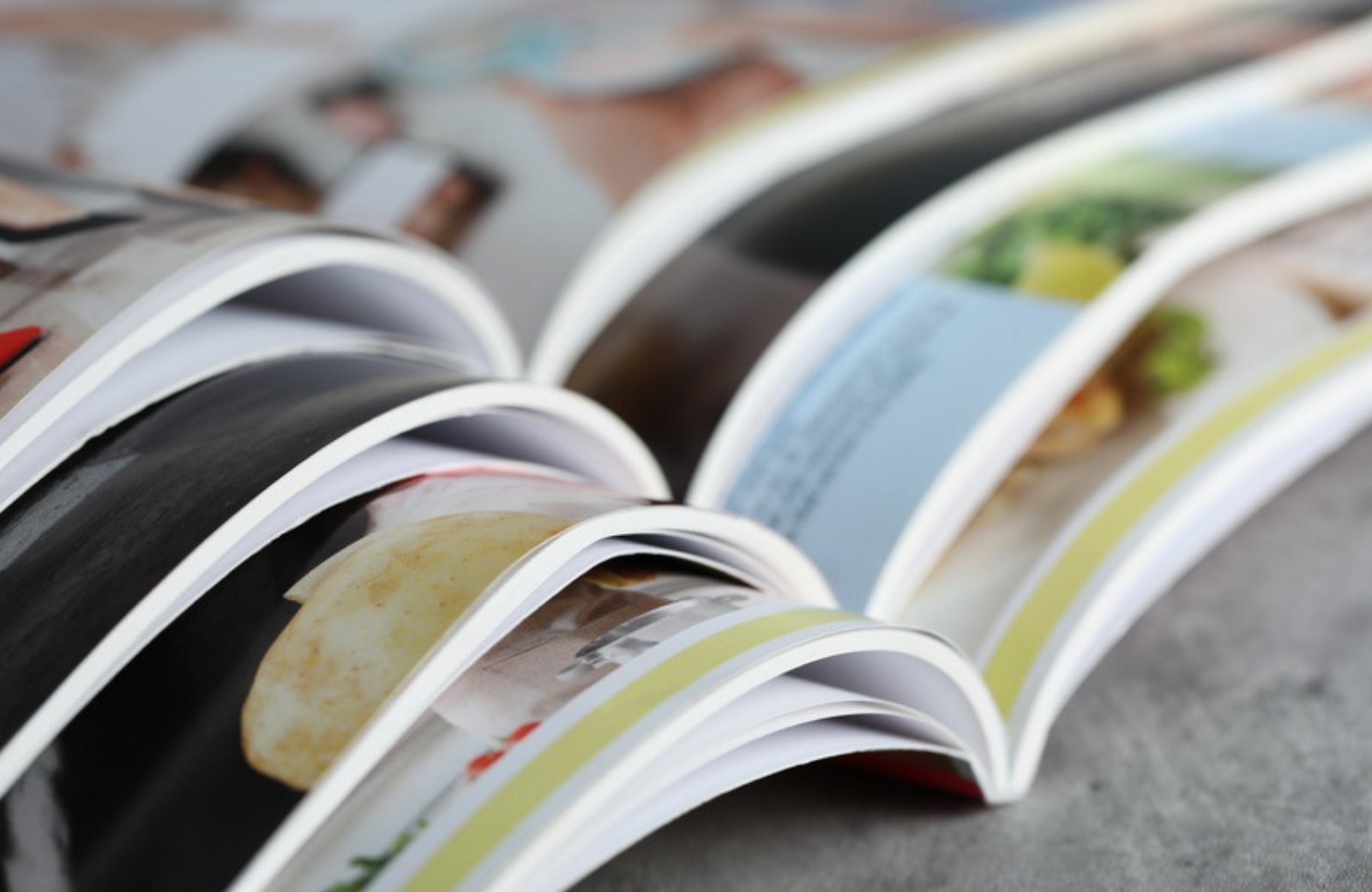 Open magazines spread across a table