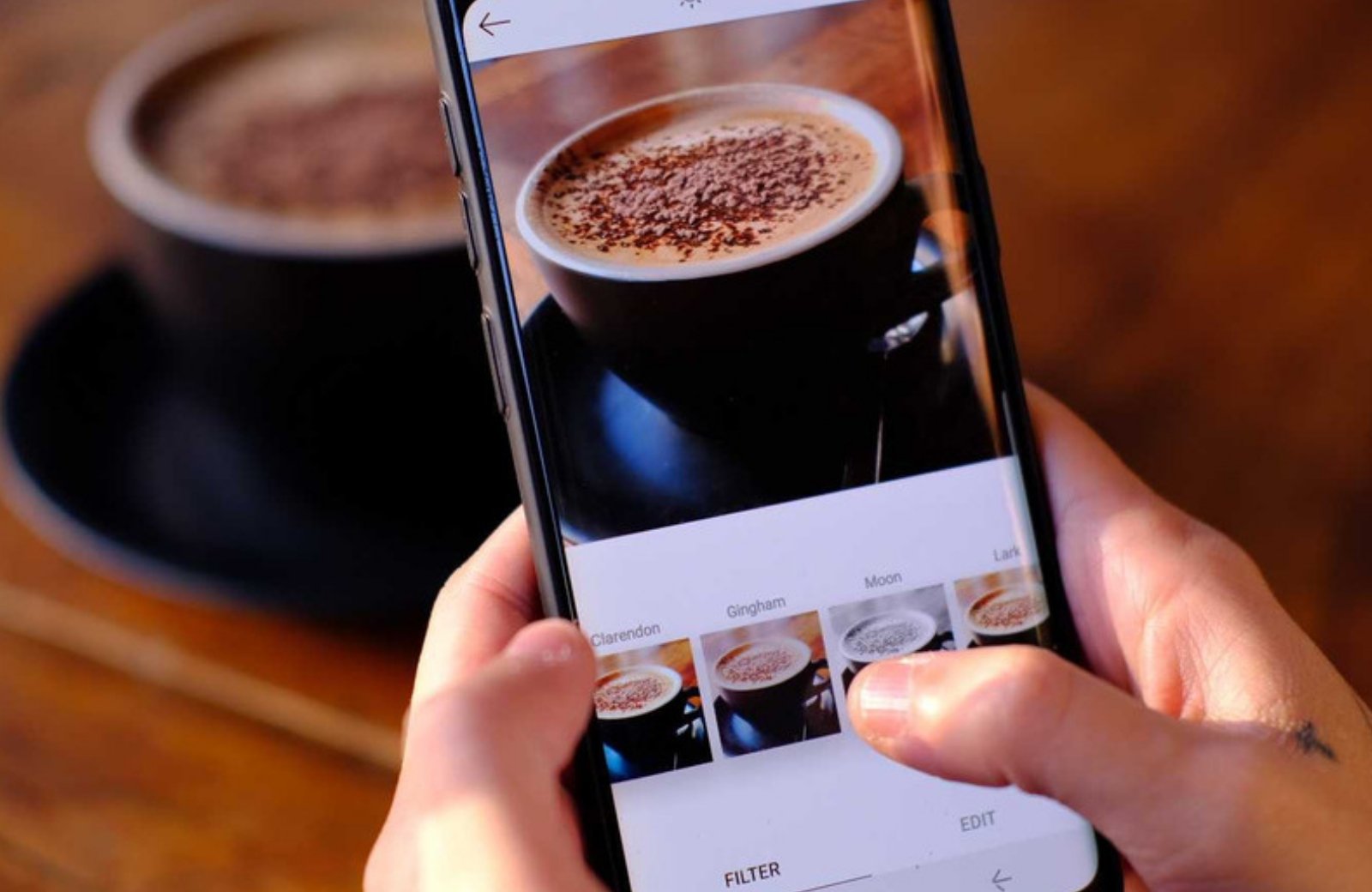 Phone editing a coffee photo with filters for social media