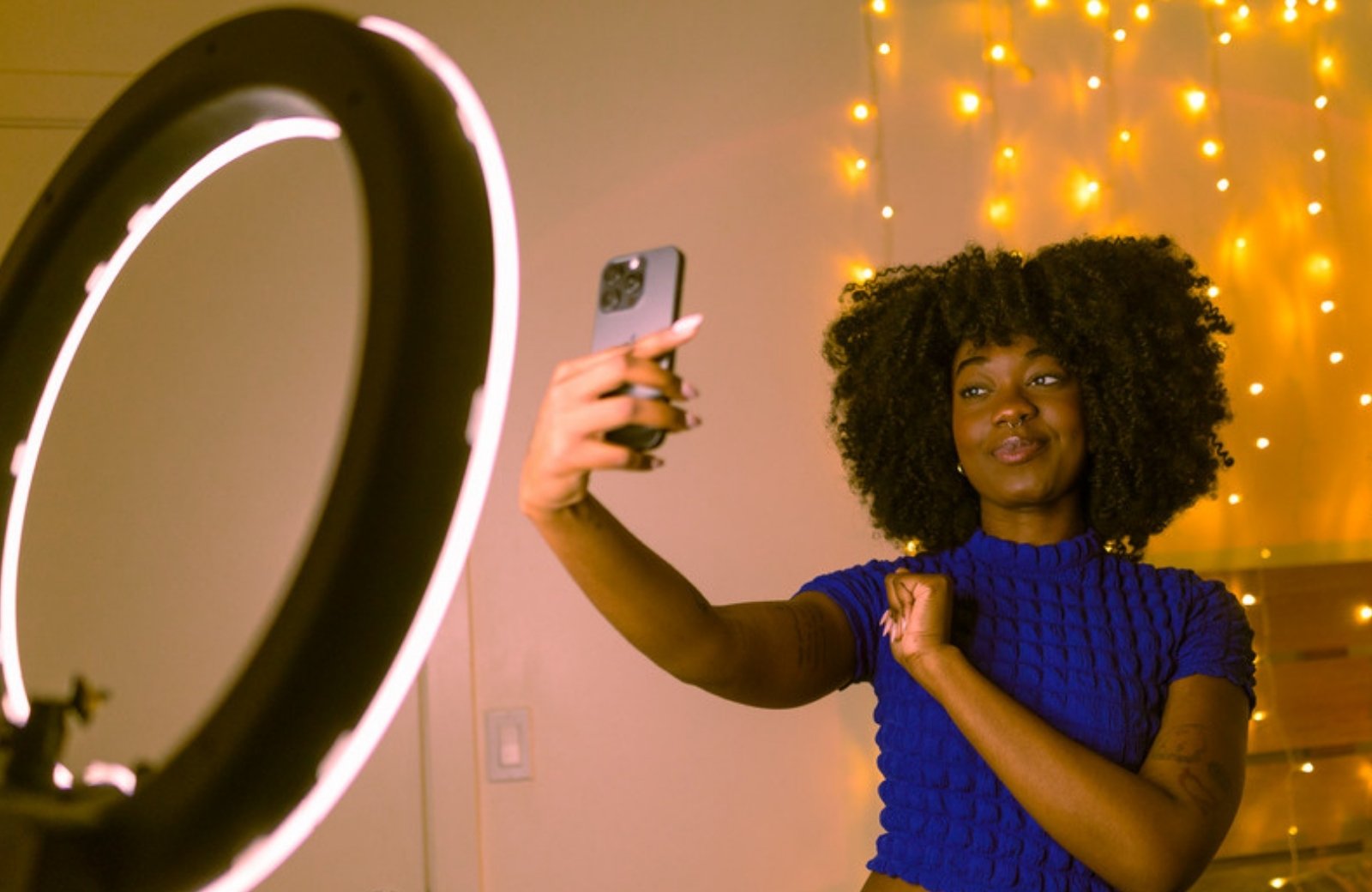 Content creator filming a social media video with a phone and ring light Content creator filming a social media video with a phone and ring light