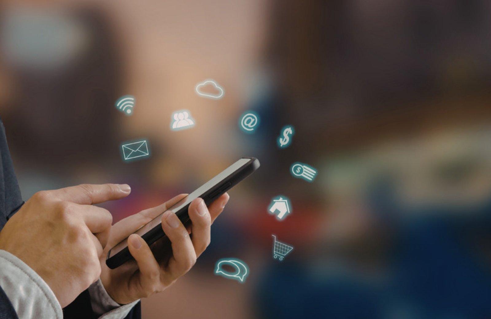 Hand holding a smartphone with social media and messaging icons